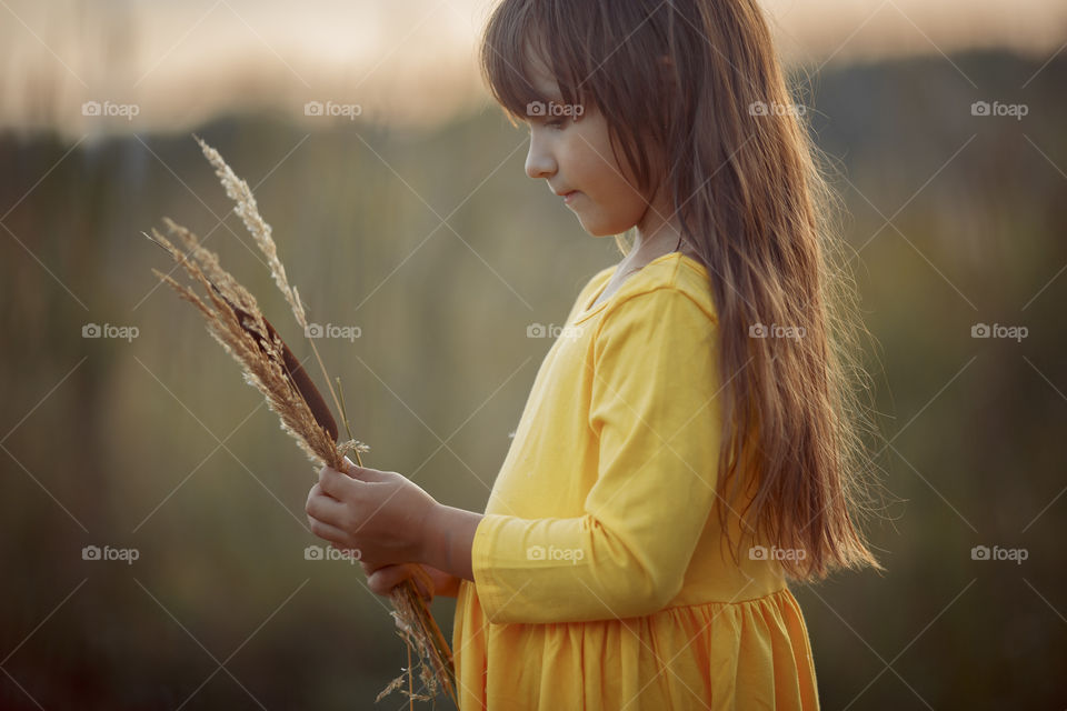 Little girl in yellow dress outdoor portrait 