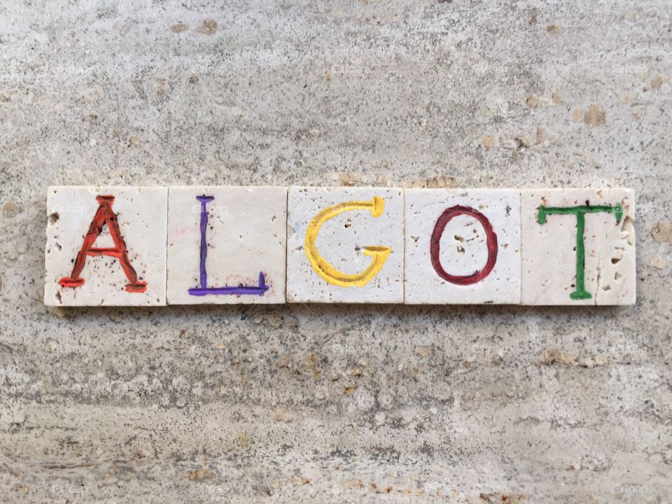 Algot, swedish male name. Composition with carved travertine pieces of Algot, swedish masculine name