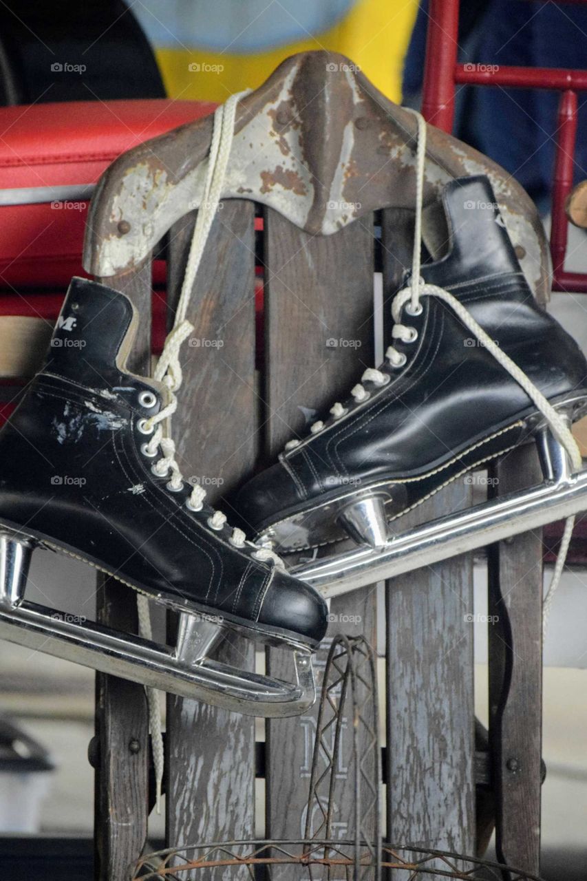 Close-up of ice skate hanging on metal