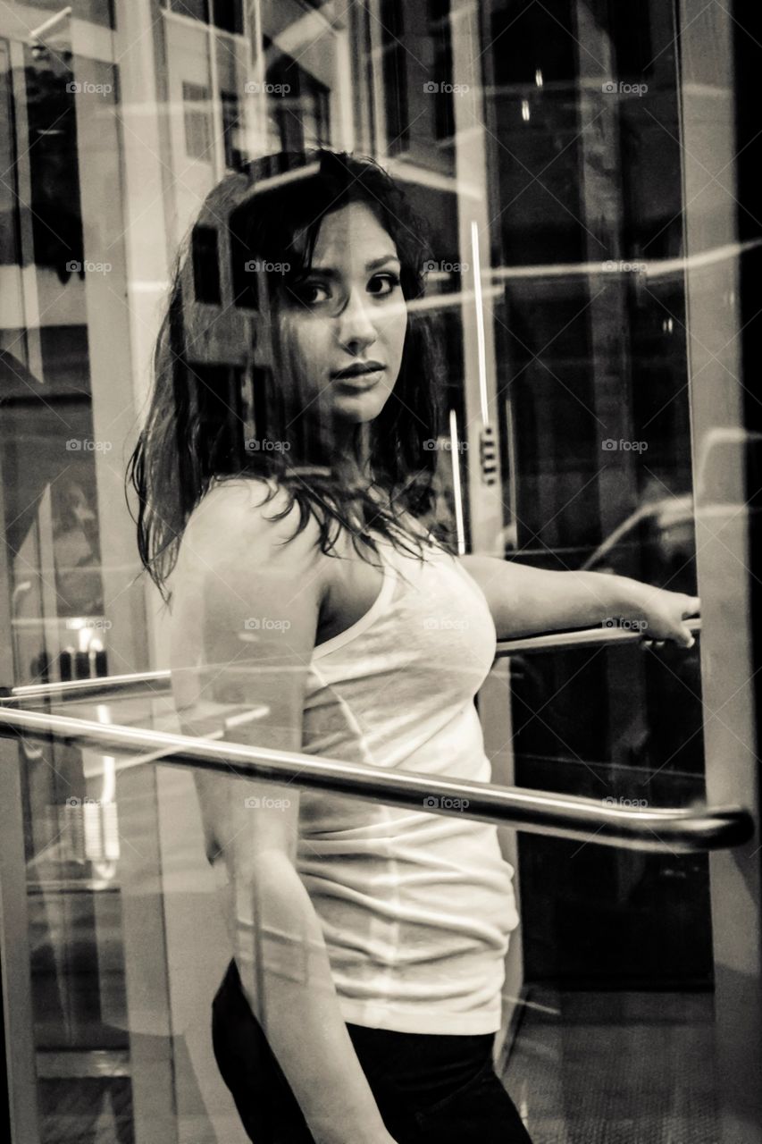 Urban woman through window reflection 