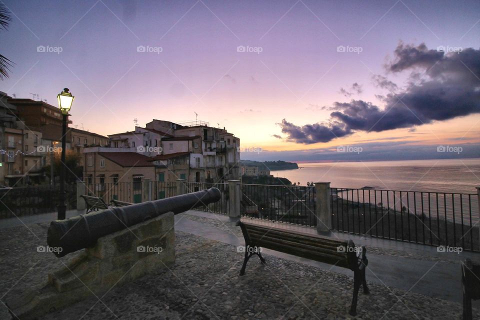 Old cannon and idyllic sea at sunset