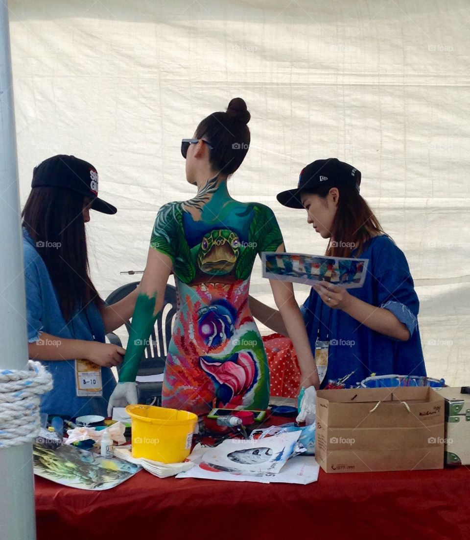 Turtle . Model getting painted for the 2015 Daegu body painting festival in Daegu, South Korea 