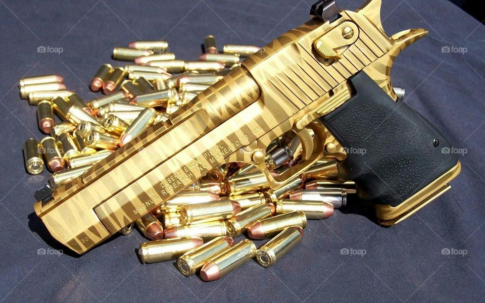 gold pistol and bullet