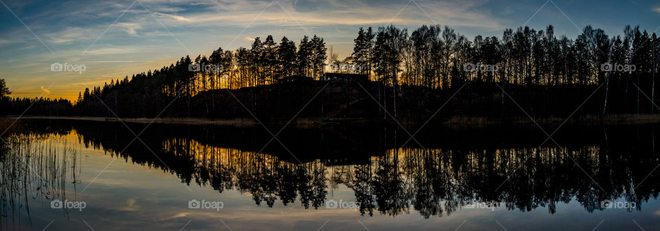 just after sunset in the golden hour of photography to get this beautiful sunset panorama. the reflection on the smooth lake makes this shot work
