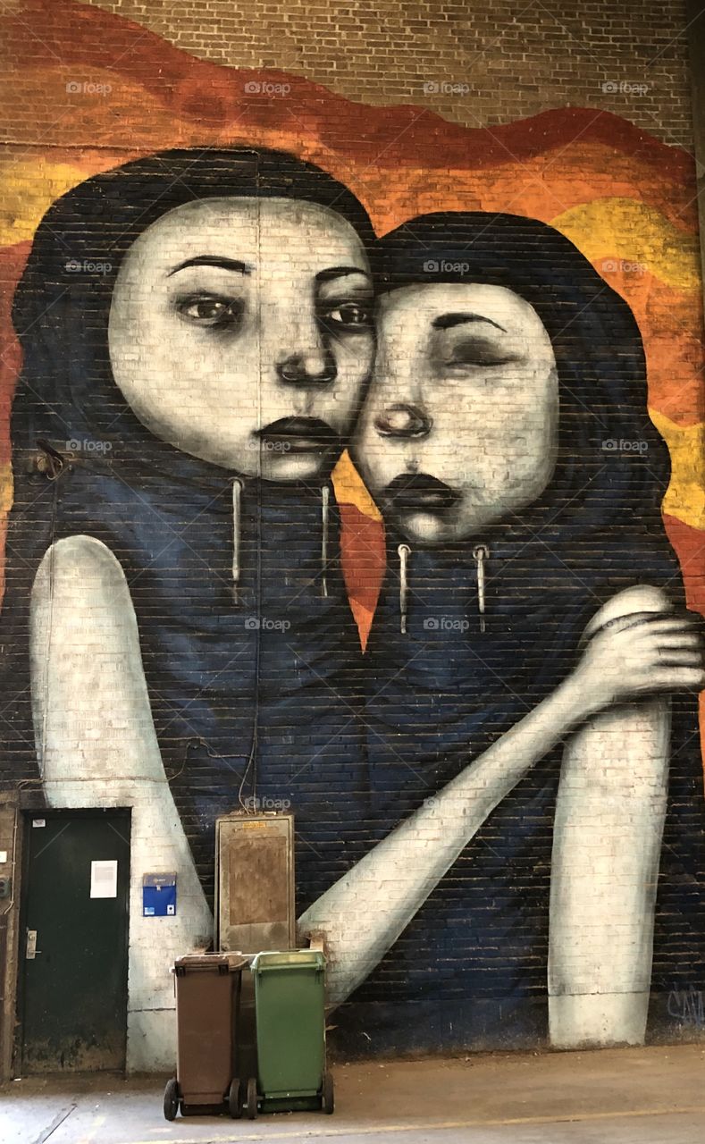 Two women street art on wall