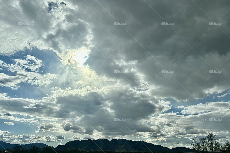 A photo of a cloudy sky with mountains. 
