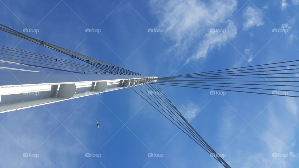 image of a pedestrian suspension bridge looking up at the sky