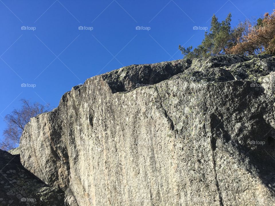 Blue sky and synshine over a huge cliff 