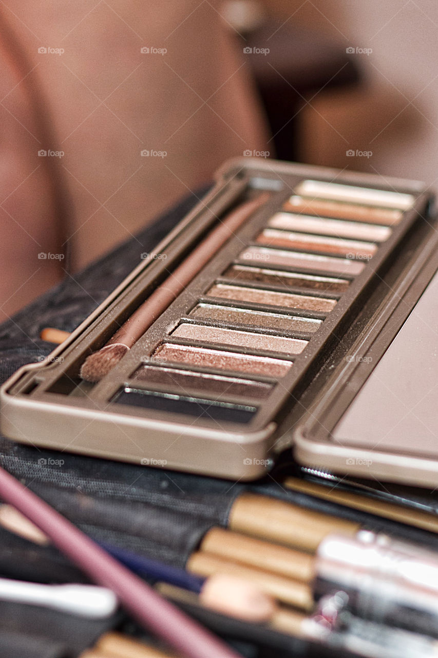 Close-up of eyeshadows and make-up brush