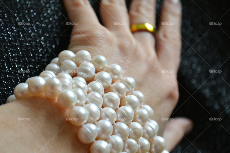 female hand with bracelet pearls beautiful accessories close up