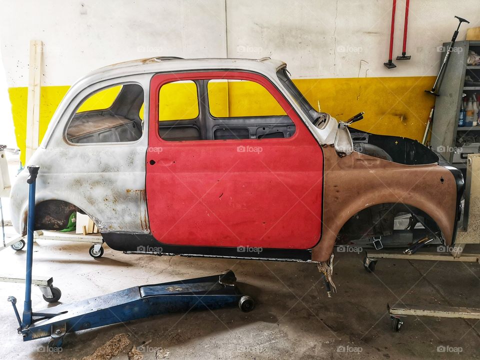 Old Fiat 500 by the mechanic to be repaired