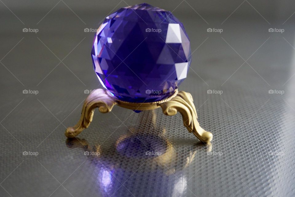 A multi faceted crystal sphere, often times used by Feng Shui Practioners in spaces to remedy chi energy. Creates a sparkling effect from refracted light.