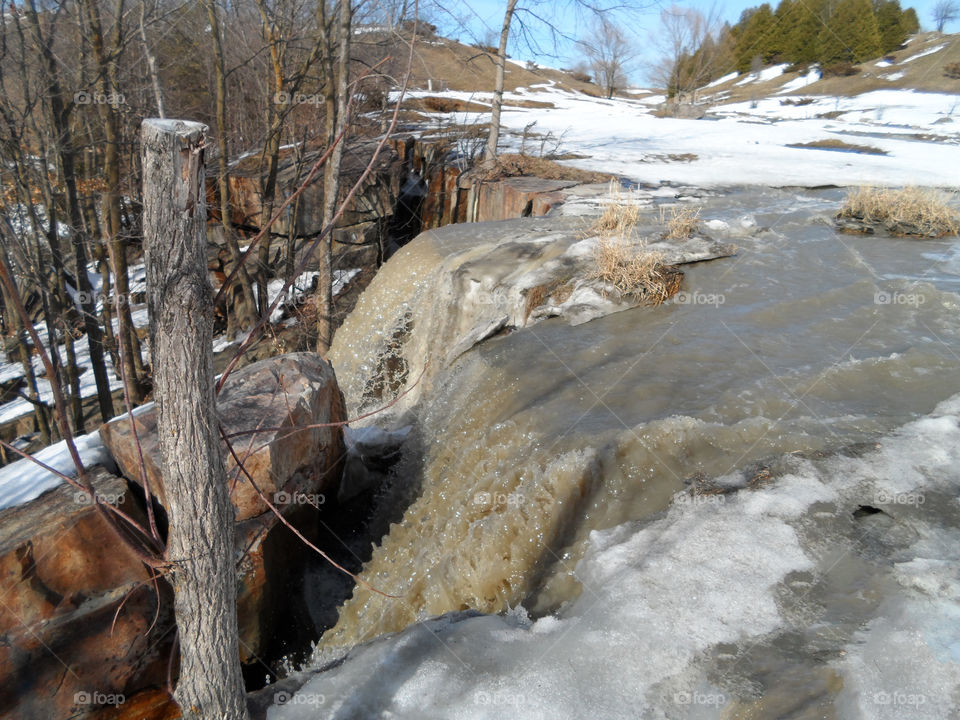 Waterfalls in the field. Spring snow melting causing waterfalls
