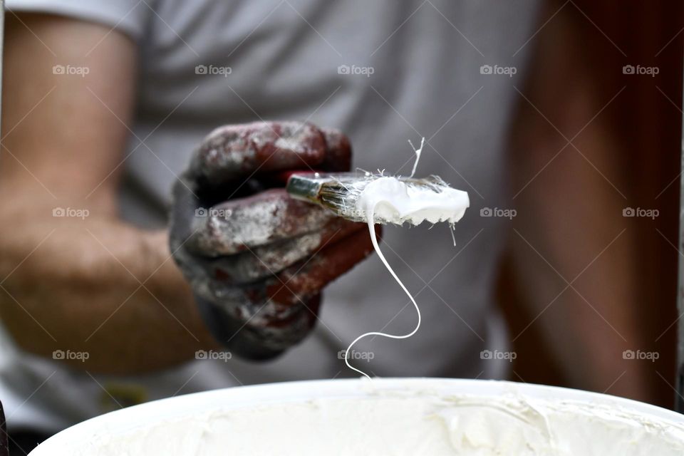 Man painting with white color 