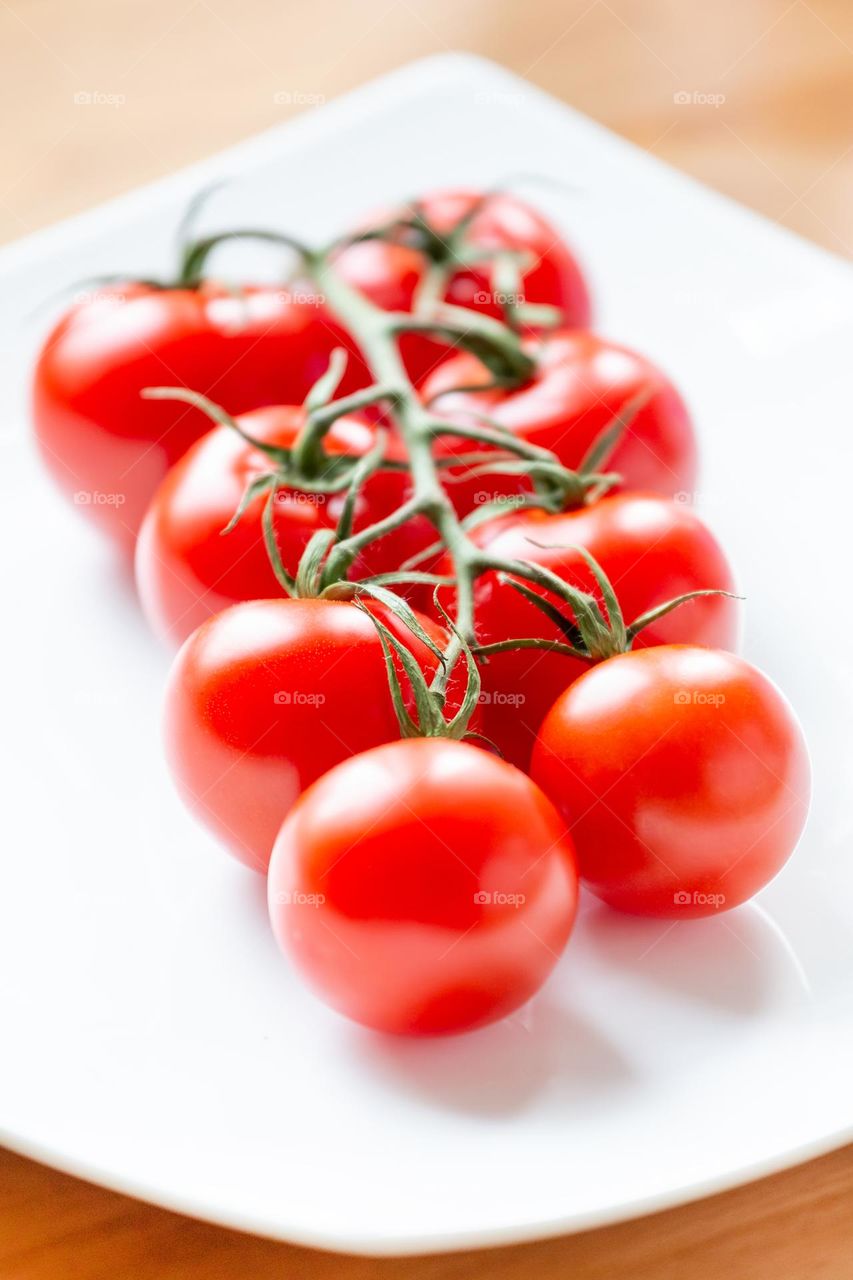 Organic juicy bunch of cherry tomatoes, closeup