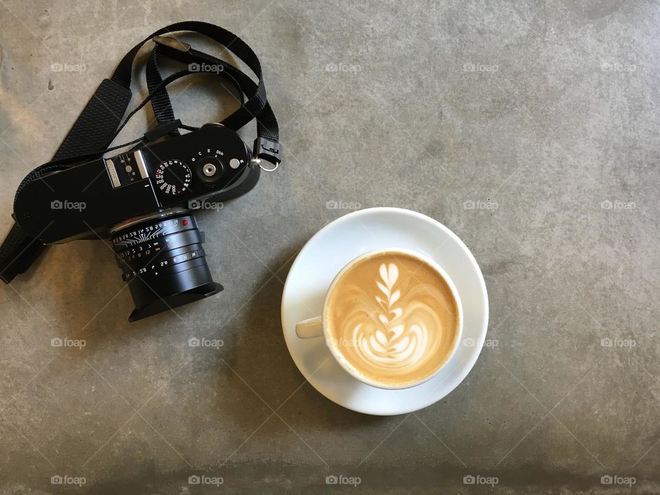 Creamy coffee drink next to the camera.
First the caffeine, then the photos.