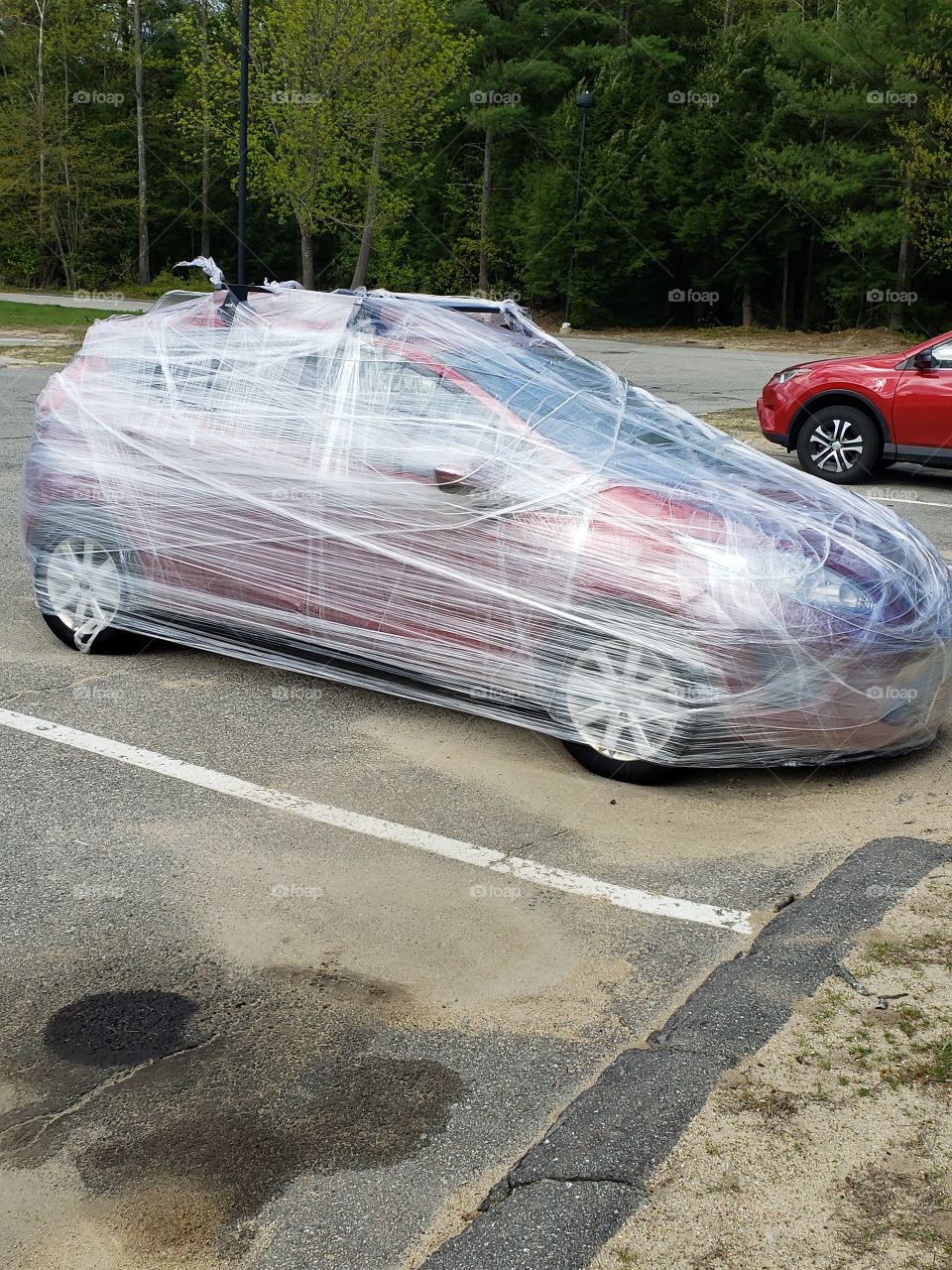 red car plastic wrapped car prank