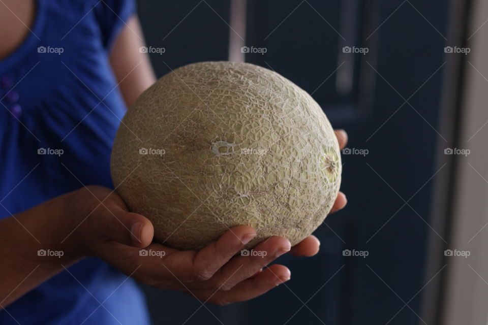 Woman holding cantaloupe