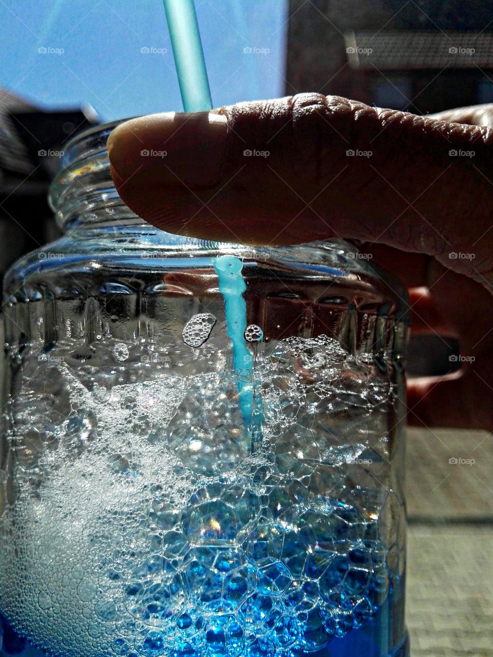 holding glass with bubbles