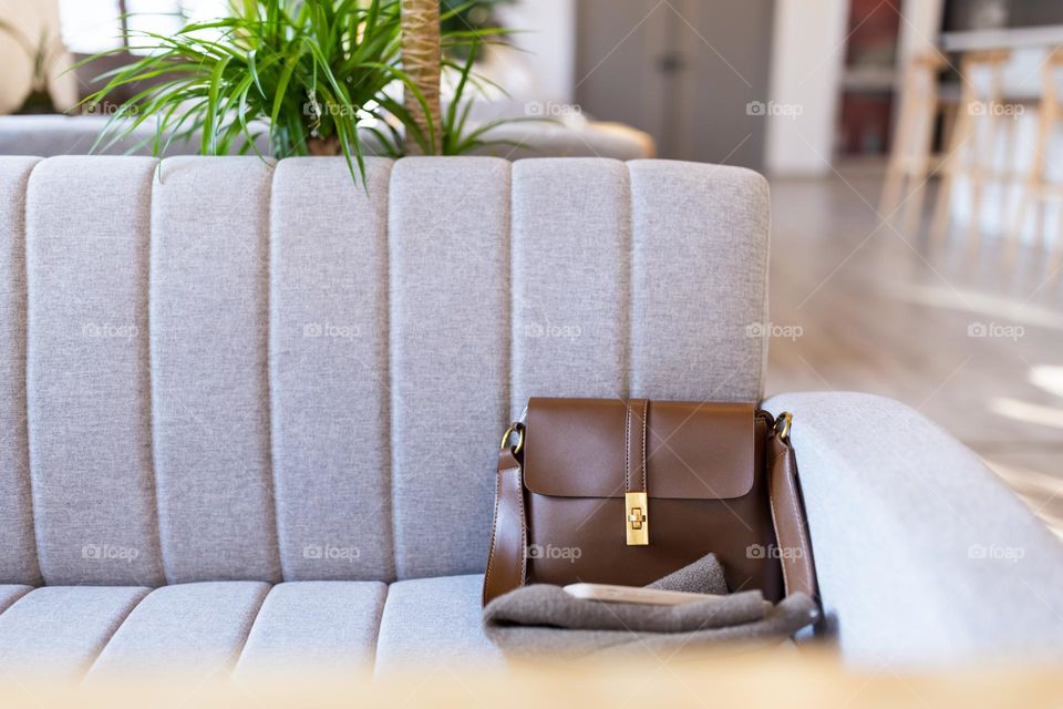 Female bag lying on couch in cafe