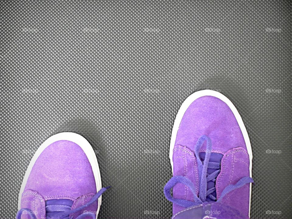 Purple sneakers on treadmill 
