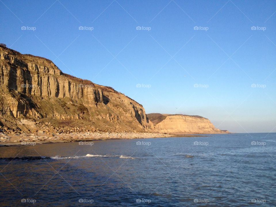 Scenic view of sea by cliff