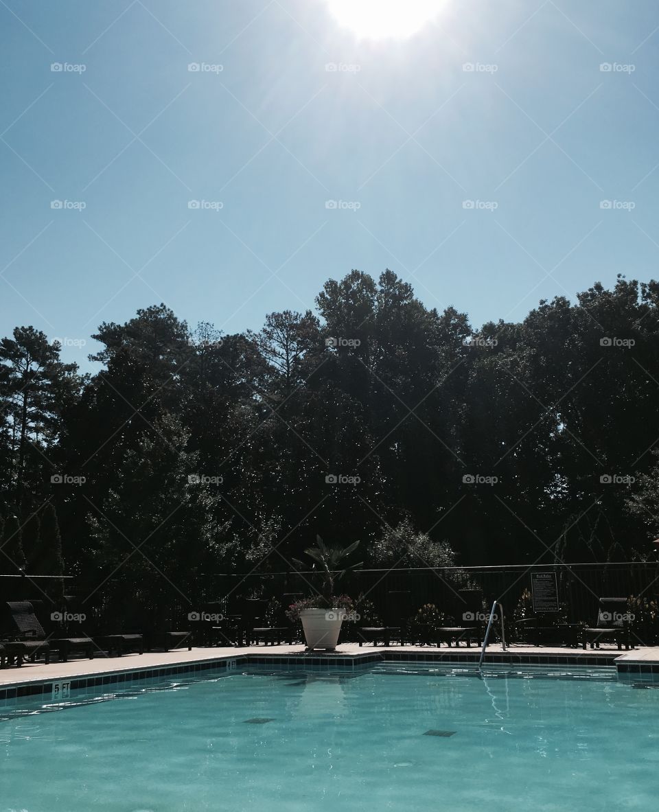 Sun burst over swimming pool 