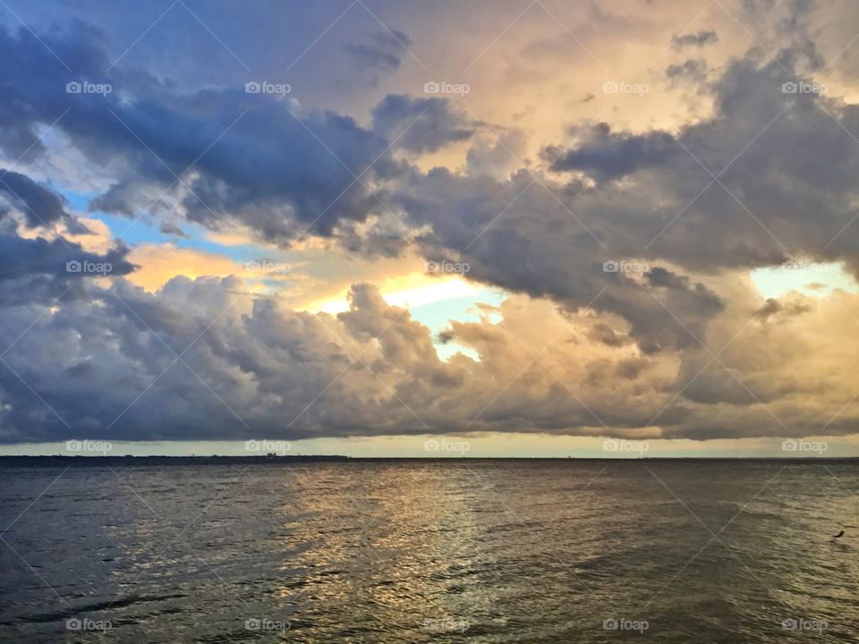 
Spectacular sunset through the storm clouds over the bay. In addition to being illuminated longer, the higher the clouds are, so do they reflect more impressive colors. 