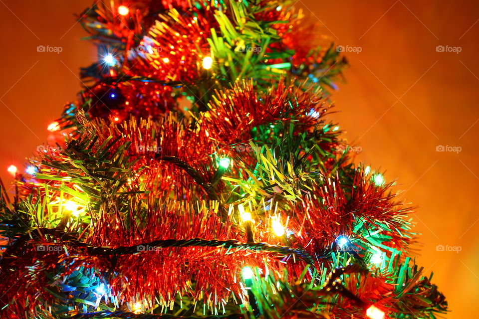 Macro shot of Christmas tree decorations and vivid lights