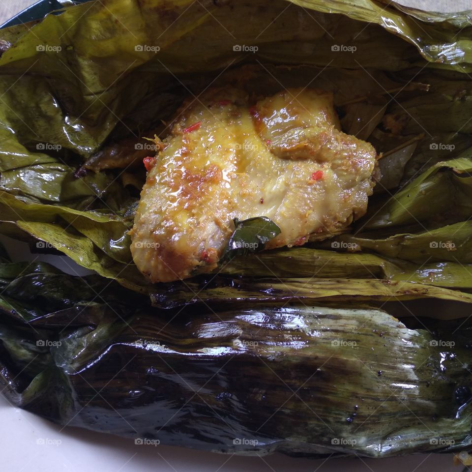 Steamed chicken wrapped in banana leaves