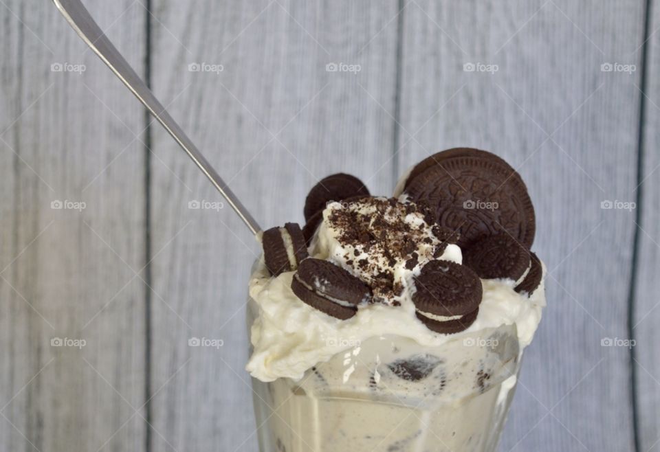 Oreo cookie milkshake with a wooden rustic white background