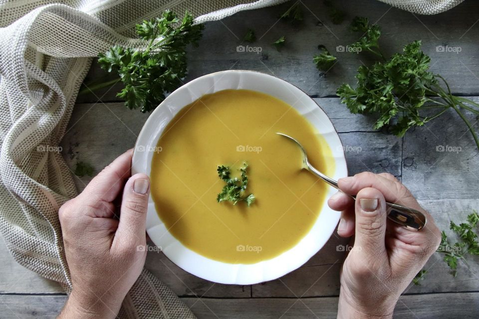 Man eating healthy New Years resolution butternut squash soup flat lay