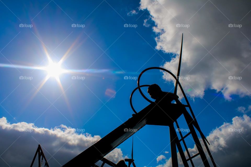 Child silhouette on slide in playground, Portugal 2022
