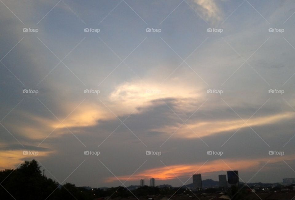 Sunset with different color clouds .