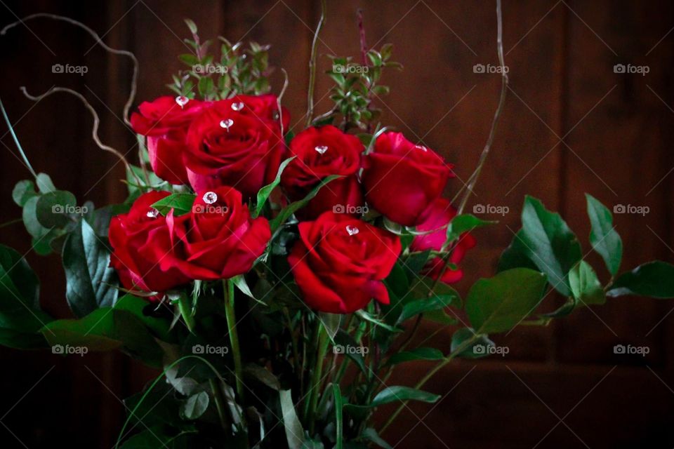 This photo features a lovely bouquet of red roses with faux diamonds. 