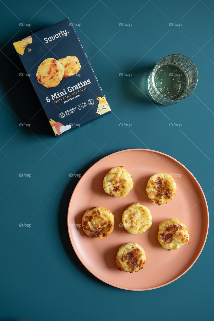 Flat lay of a box of Savorly and gratin bites on a plate 