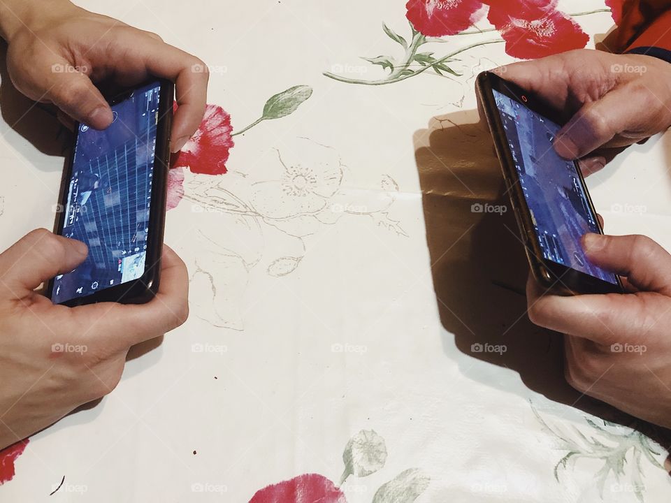 People gaming PUGB with smartphones