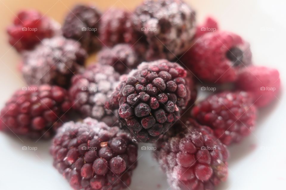 Frozen blackberries on table