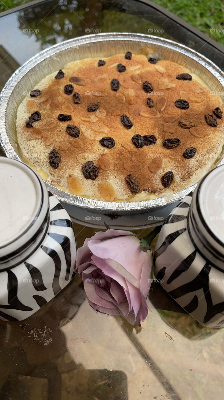 Coconut cake baked with raisins on top always nice to try as a dessert, the jars and flower just for decoration
