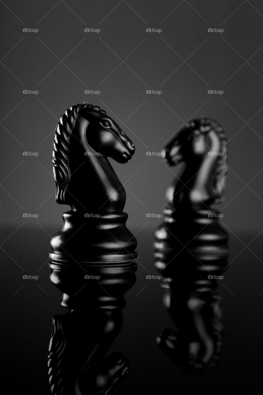 Knight's strategy - Chess game coin on black