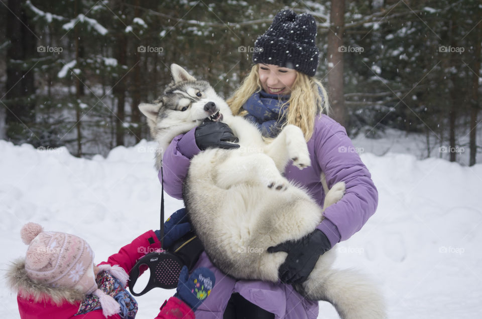 mother with daughter and dog husky