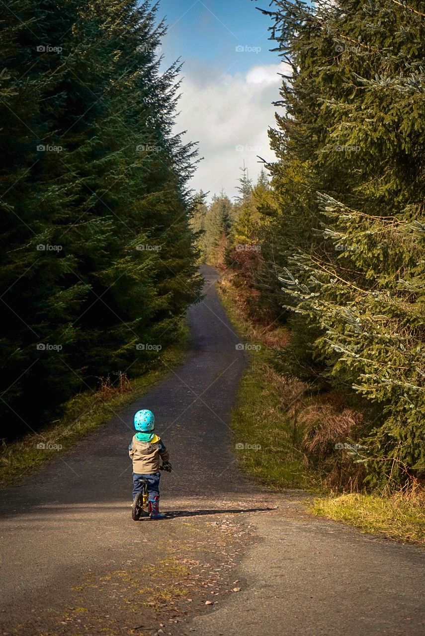 Boy looking at long road ahead