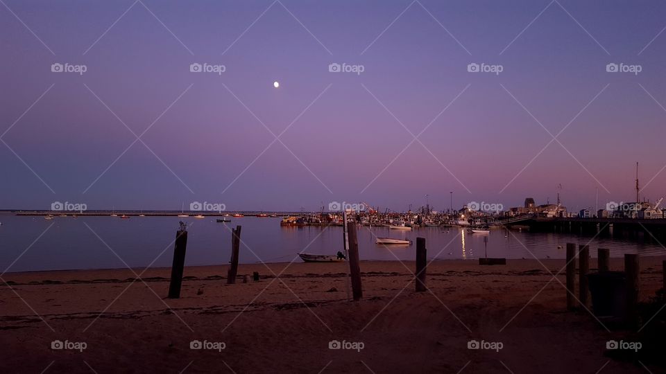 sunset with a bright moon in Provincetown, MA Capecod