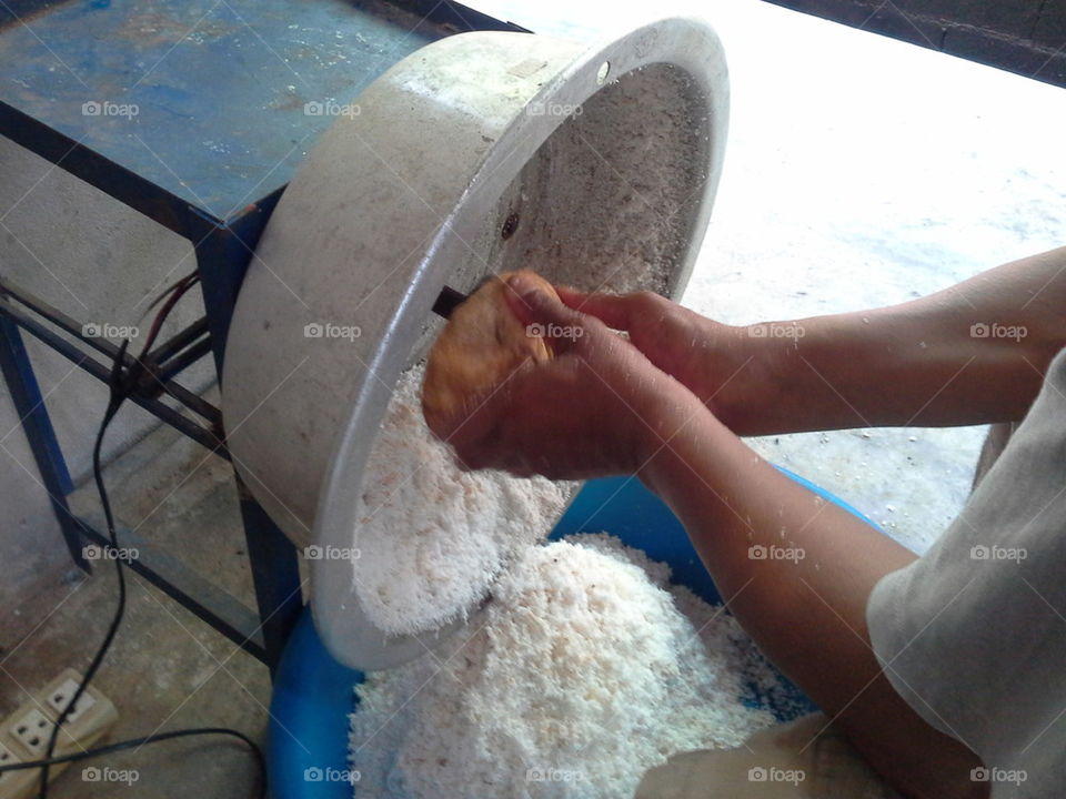 Close up of Thai man hand that coconut grating machine