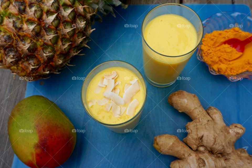 Mango pineapple ginger turmeric smoothies with toasted coconut 