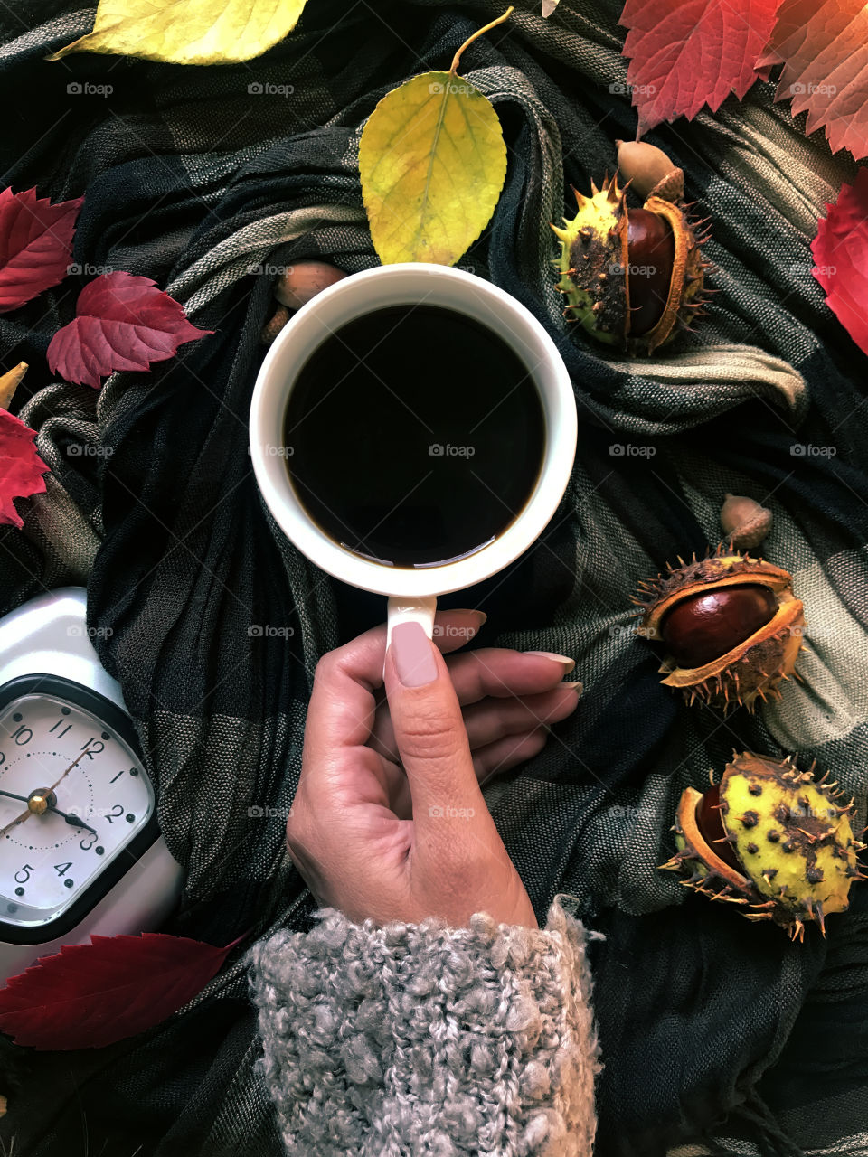 Drinking hot coffee in cozy sweater in autumn 