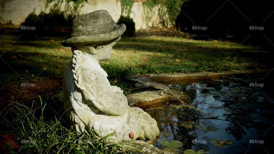 Statue by a pond