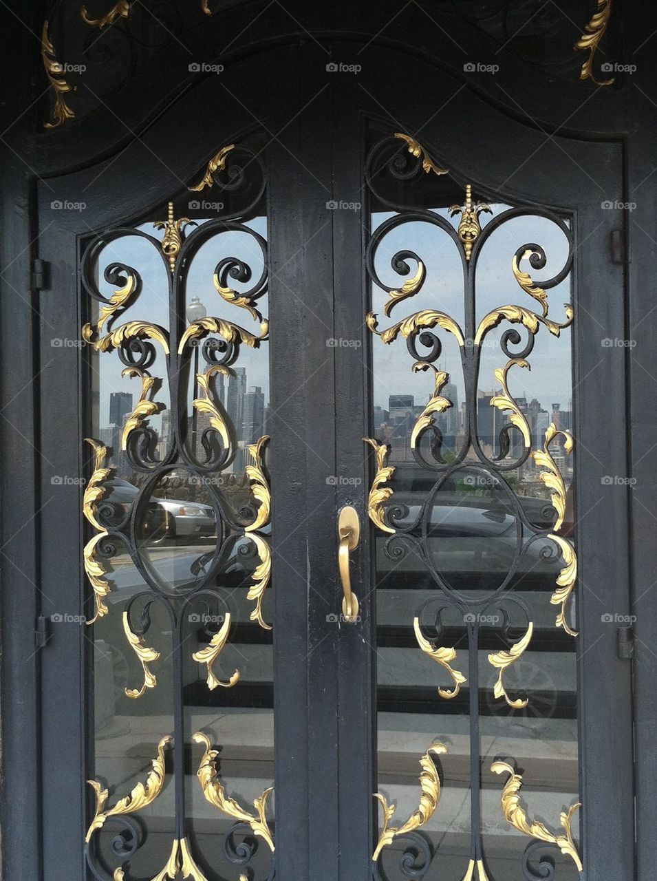 Black gold doors New York reflection