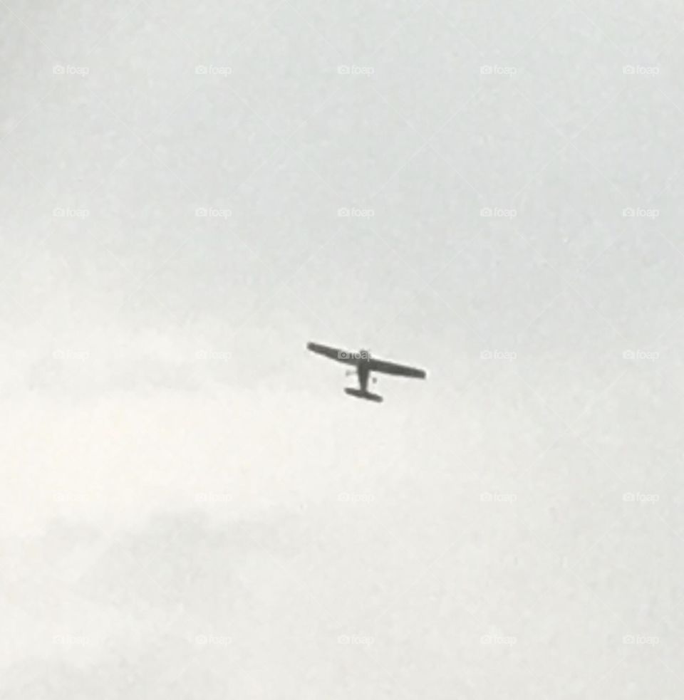 Small aircraft plane was one of many flying in a plane airshow, one cloudy day, in Medicine Hat, Alberta, Canada 
