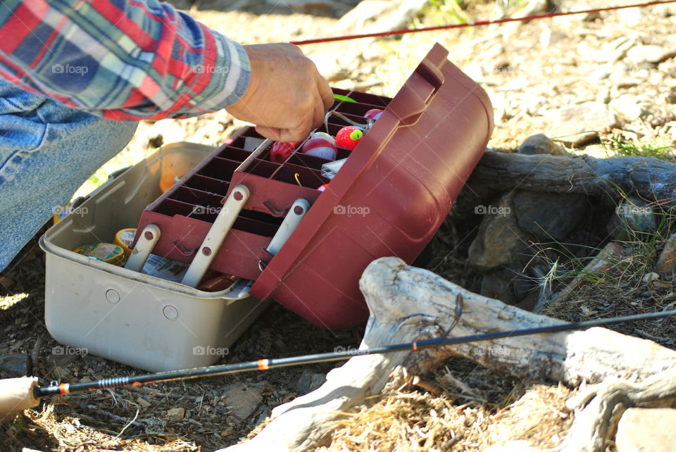 photo story of a man his hands on the works setting up the fishing rod